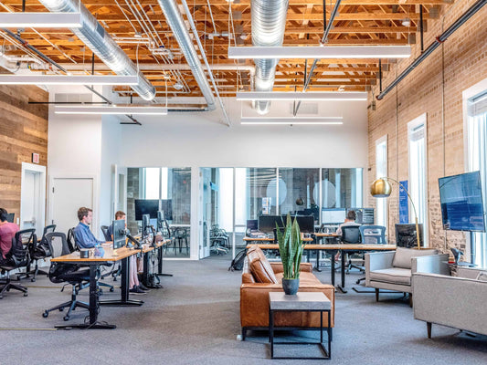 modern office with open floor plan and employees sitting at desks working on computers