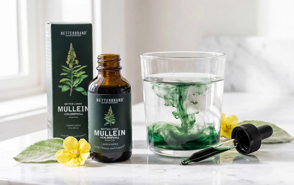 BetterLungs Mullein + Chlorophyll tincture and box beside a glass with green chlorophyll dispersing, on a marble counter